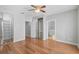 This bedroom features hardwood floors, a ceiling fan, a closet and a door to the bathroom at 1605 Napoli W Dr, Sarasota, FL 34232