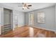 This bedroom features hardwood floors, a ceiling fan, a closet and a door to the bathroom at 1605 Napoli W Dr, Sarasota, FL 34232