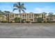 Townhome exterior featuring an eye-catching color, manicured landscaping, and private balconies at 1605 Napoli W Dr, Sarasota, FL 34232
