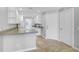 Kitchen area featuring tile flooring, light countertops, and white cabinetry, with a door to the exterior at 1605 Napoli W Dr, Sarasota, FL 34232