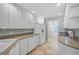 Bright kitchen with neutral countertops, ample cabinets, and tiled flooring, providing a clean and organized space at 1605 Napoli W Dr, Sarasota, FL 34232