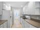 A functional kitchen featuring all-white appliances, light countertops, and ample cabinet space for convenient storage at 1605 Napoli W Dr, Sarasota, FL 34232