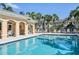 Resort-style pool with ample lounge chairs and covered seating area with ceiling fans at 1605 Napoli W Dr, Sarasota, FL 34232