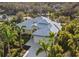 Stunning aerial view of the beautiful, light green home featuring a gray roof and surrounded by lush greenery at 2500 Jamaica St, Sarasota, FL 34231