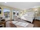 Bright primary bedroom with dark wood floors, French doors, and a serene sitting area for relaxation at 2500 Jamaica St, Sarasota, FL 34231