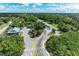 An aerial view showcases the home near a parking lot and surrounding lush greenery and landscape at 362 Pine Run Dr, Osprey, FL 34229