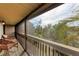 Relaxing screened-in balcony with wicker chairs overlooking tropical greenery at 362 Pine Run Dr, Osprey, FL 34229