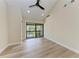 Light-filled bedroom featuring wood flooring and a private balcony at 362 Pine Run Dr, Osprey, FL 34229