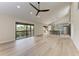 Open concept living room and kitchen with modern design, vaulted ceilings, and a fan at 362 Pine Run Dr, Osprey, FL 34229