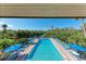 Serene view of pool and waterway with relaxing lounge seating for residents enjoyment at 362 Pine Run Dr, Osprey, FL 34229