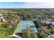 Aerial view of multiple tennis courts nestled in a lush community at 362 Pine Run Dr, Osprey, FL 34229