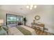 Bright primary bedroom featuring a screened patio, woven accents, and a wood-look floor at 4118 Southwell Way, Sarasota, FL 34241