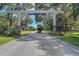 Entrance to Myakka Valley Ranches community with stone pillars and a gated road at 4939 Myakka Valley Trl, Sarasota, FL 34241