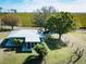 Aerial view showcasing the backyard and screened patio of a cozy home surrounded by lush greenery at 4939 Myakka Valley Trl, Sarasota, FL 34241