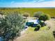 Aerial view of charming home on expansive property with lush landscaping and a vibrant green field backdrop at 4939 Myakka Valley Trl, Sarasota, FL 34241