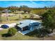 Aerial view of well-maintained home with screened patio, and a nearby blue vehicle on a grassy lot at 4939 Myakka Valley Trl, Sarasota, FL 34241