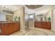 Luxurious primary bathroom features dual vanities, a glass-enclosed shower, and elegant tile flooring at 505 S Orange Ave # 501, Sarasota, FL 34236