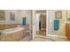 Elegant bathroom features a soaking tub with tile surround, opening to walk-in closet at 505 S Orange Ave # 501, Sarasota, FL 34236