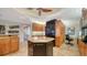 Spacious kitchen with granite countertops, central island, black appliances, and ample cabinet space at 505 S Orange Ave # 501, Sarasota, FL 34236