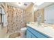 Bathroom with seashell themed shower curtain and blue vanity at 535 Spring Lakes Blvd, Bradenton, FL 34210