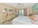 Bright bedroom with ceiling fan, dresser, desk, and sliding glass door to the outside at 535 Spring Lakes Blvd, Bradenton, FL 34210