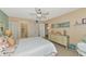 Bedroom with patterned bedding, dresser, and neutral walls at 535 Spring Lakes Blvd, Bradenton, FL 34210