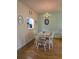 Charming dining area featuring a light fixture above a wooden table, complemented by a view of the kitchen at 535 Spring Lakes Blvd, Bradenton, FL 34210