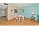 Cozy dining area with a wood-look floor and a view into the kitchen at 535 Spring Lakes Blvd, Bradenton, FL 34210