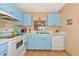 Kitchen with light blue cabinets, white countertops, and appliances at 535 Spring Lakes Blvd, Bradenton, FL 34210