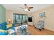 Cozy living room featuring sliding doors to the lanai, complemented by a ceiling fan and coastal decor at 535 Spring Lakes Blvd, Bradenton, FL 34210