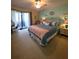 Comfortable main bedroom with a ceiling fan, slider to the lanai, and cozy furnishings at 535 Spring Lakes Blvd, Bradenton, FL 34210