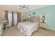 Serene main bedroom with a ceiling fan, slider to the lanai, and coastal-inspired decor at 535 Spring Lakes Blvd, Bradenton, FL 34210