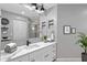 Modern bathroom featuring an undermount sink, a large mirror, and brushed gold hardware at 6706 Fairway Gardens Dr # 6706, Bradenton, FL 34203