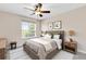 Cozy bedroom features a ceiling fan, a large window, and ample natural light at 6706 Fairway Gardens Dr # 6706, Bradenton, FL 34203
