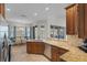 Kitchen featuring a large island, stainless steel appliances, and access to dining area at 7518 Paspalum, Punta Gorda, FL 33955