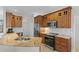 Kitchen featuring granite counters, stainless steel appliances, and wood cabinets at 7518 Paspalum, Punta Gorda, FL 33955