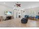 Spacious living room with tile floors, a ceiling fan, and an archway at 7518 Paspalum, Punta Gorda, FL 33955