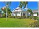 Exterior shot of the community clubhouse with well-manicured grounds and palm trees at 9413 Andover Cir, Bradenton, FL 34210