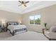 Serene bedroom features a large window, neutral palette, tray ceiling, and soft carpet at 12029 Perennial Pl, Lakewood Ranch, FL 34211