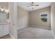 Empty bedroom with ensuite vanity features neutral walls and carpet flooring at 12029 Perennial Pl, Lakewood Ranch, FL 34211