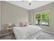 Bright bedroom features a ceiling fan, large window, and neutral decor at 12029 Perennial Pl, Lakewood Ranch, FL 34211