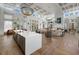Spacious clubhouse interior with stylish seating, a kitchen island, and a cozy fireplace at 12029 Perennial Pl, Lakewood Ranch, FL 34211