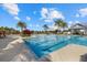Beautiful community swimming pool with clear blue water, palm trees, and lounge chairs at 12029 Perennial Pl, Lakewood Ranch, FL 34211