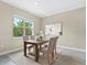 Cozy dining area with a wooden table set, neutral-toned walls and a natural-light-filled window at 12029 Perennial Pl, Lakewood Ranch, FL 34211