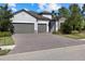 Charming single-Gathering home with a 2-car garage, stone accents, and a brick paver driveway at 12029 Perennial Pl, Lakewood Ranch, FL 34211