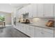The kitchen features white cabinets, granite countertops, stainless steel appliances, and a tile backsplash at 12029 Perennial Pl, Lakewood Ranch, FL 34211