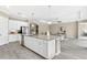 Open concept kitchen with an island, stainless steel appliances, granite countertops, and white cabinets at 12029 Perennial Pl, Lakewood Ranch, FL 34211