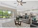 A cozy living room with an open floor plan, connecting to the kitchen and outdoor patio at 12029 Perennial Pl, Lakewood Ranch, FL 34211