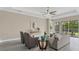 Sunlit living room featuring neutral palette, sleek tile floors, and access to a covered patio at 12029 Perennial Pl, Lakewood Ranch, FL 34211