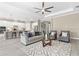 Open-concept living room featuring ceiling fan and connects to kitchen at 12029 Perennial Pl, Lakewood Ranch, FL 34211